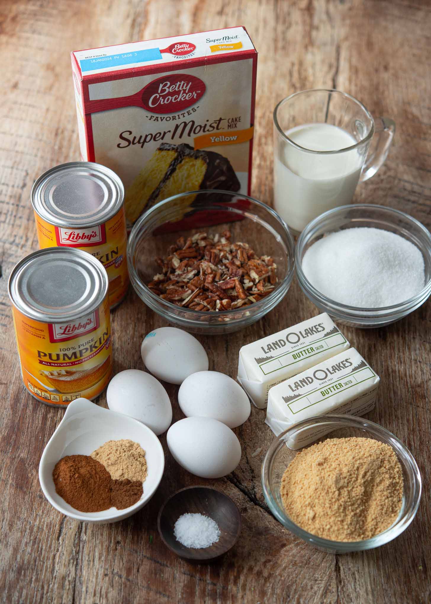 Ingredients for making pumpkin pie crunch cake presented.