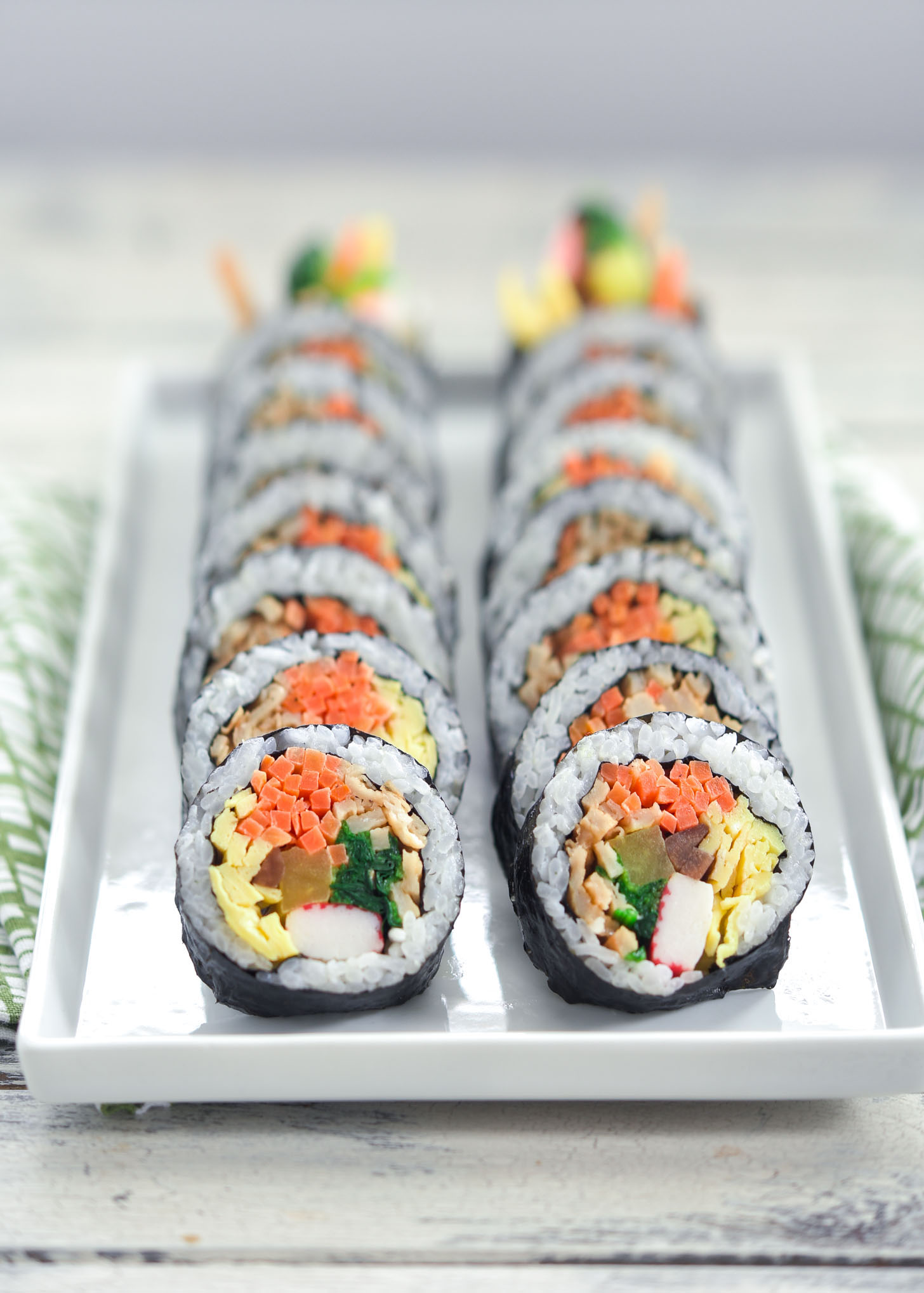 Traditional Korean seaweed rice roll slices on a serving tray.