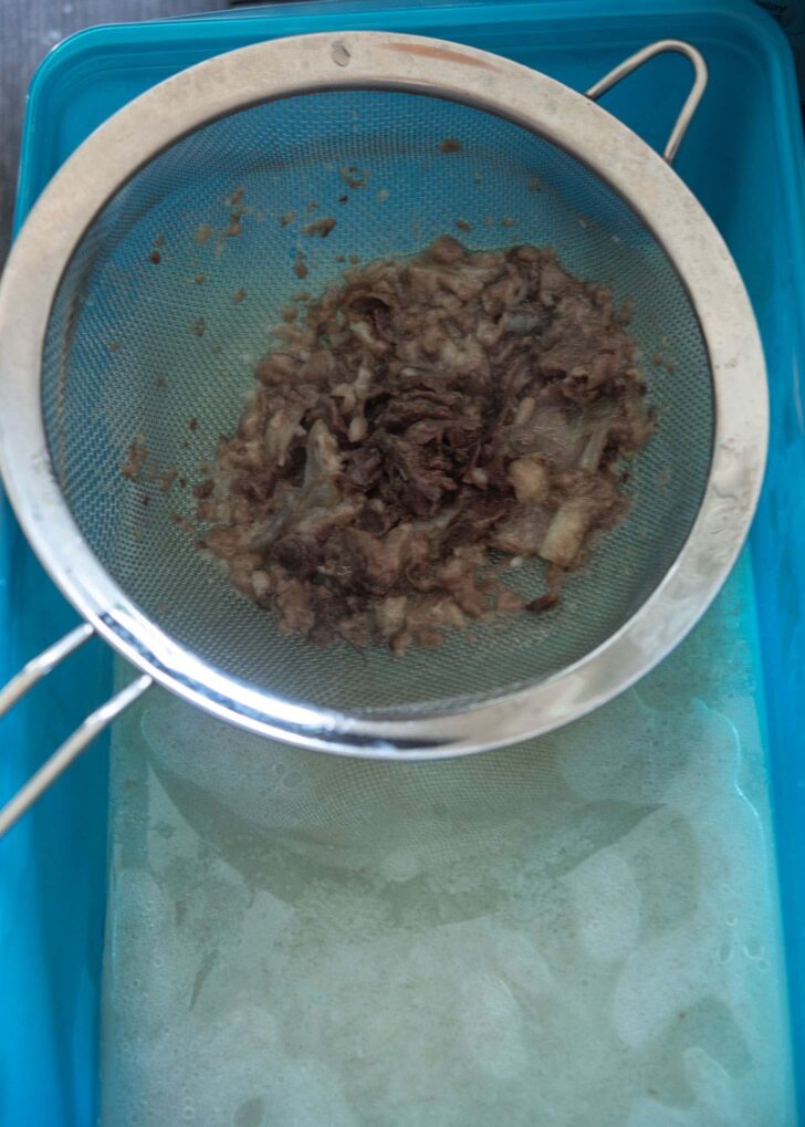 Beef bone broth drained straining meat pieces from the broth.