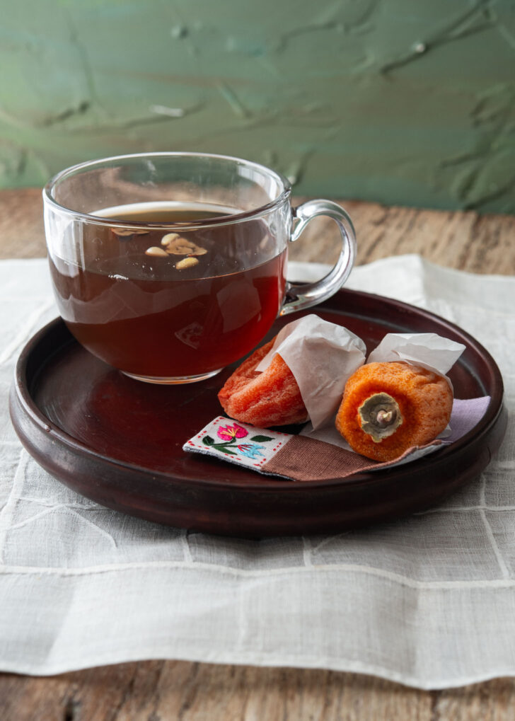 Korean cinnamon tea with dried persimmon on the side.