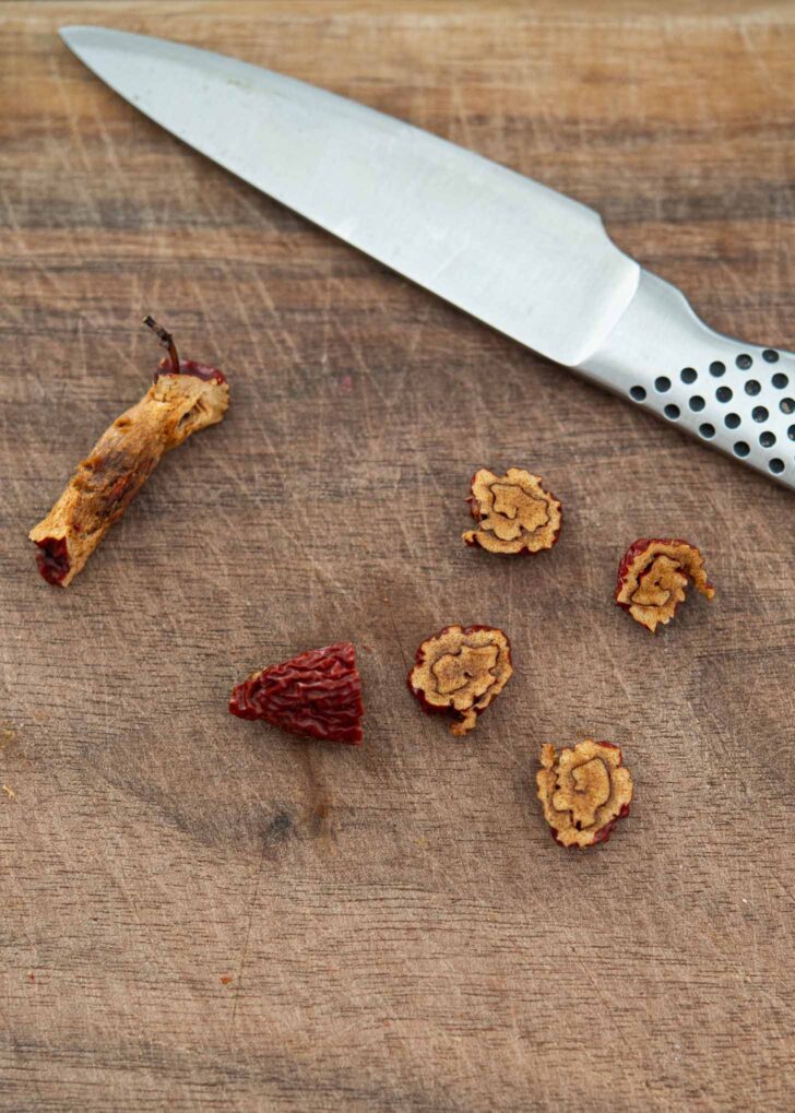 Rolled jujube sliced off with a knife creating a tiny floral pattern.