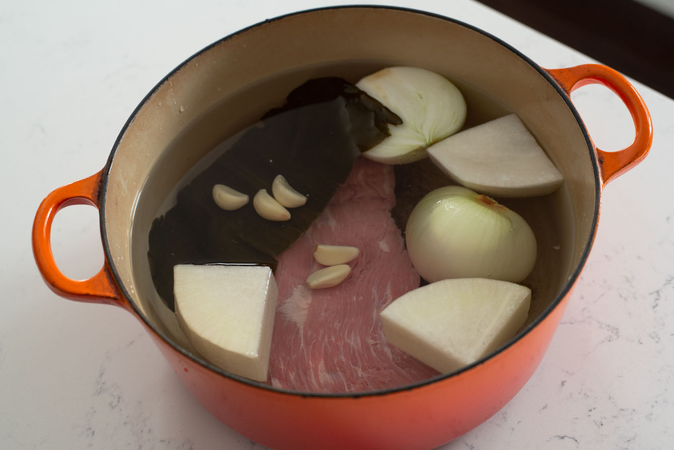 Beef broth ingredients combined in a pot.