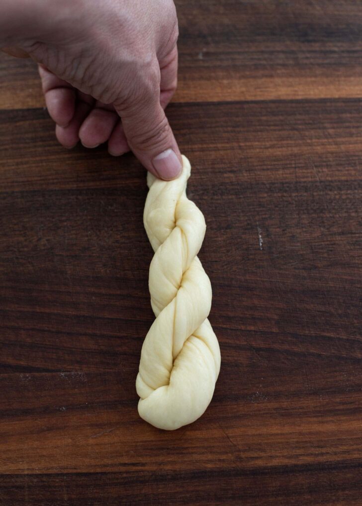 The ends of twisted dough pinched by thumb to secure.