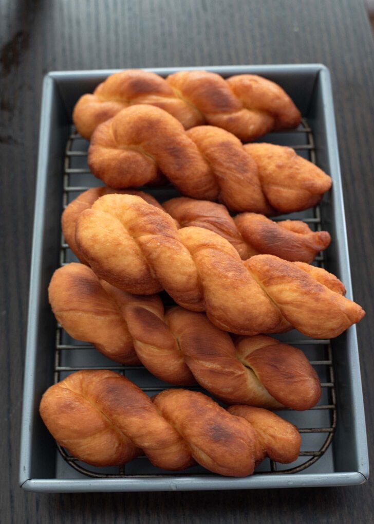 Deep fried golden brown kkwabaegi twisted donuts.