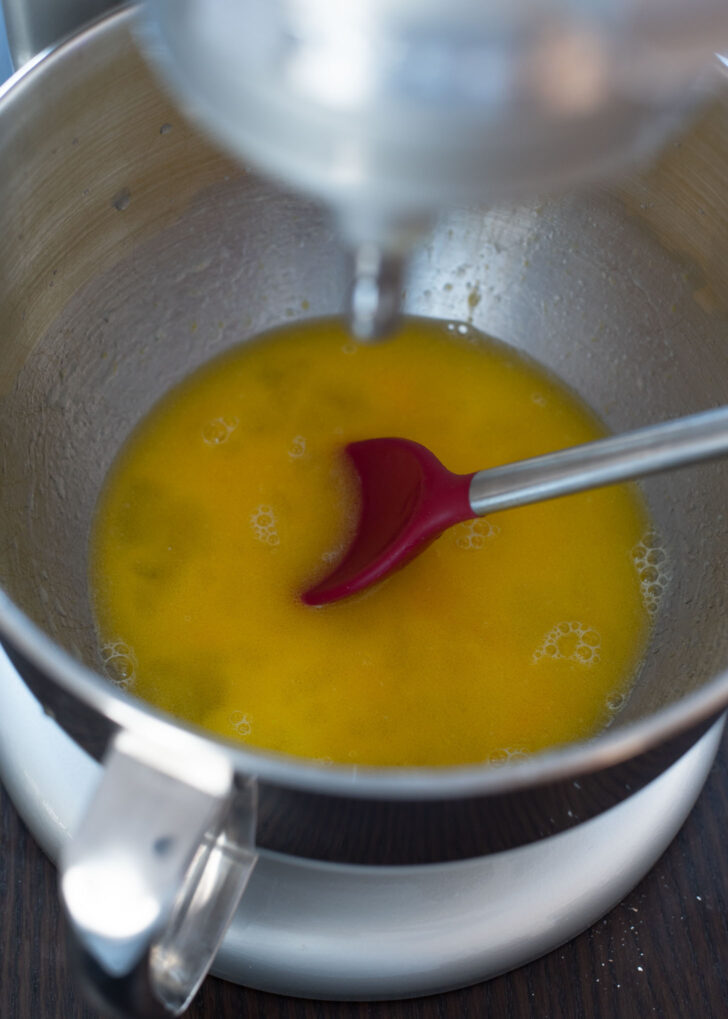 Wet ingredients for Korean twisted donuts mixed with a spoon.