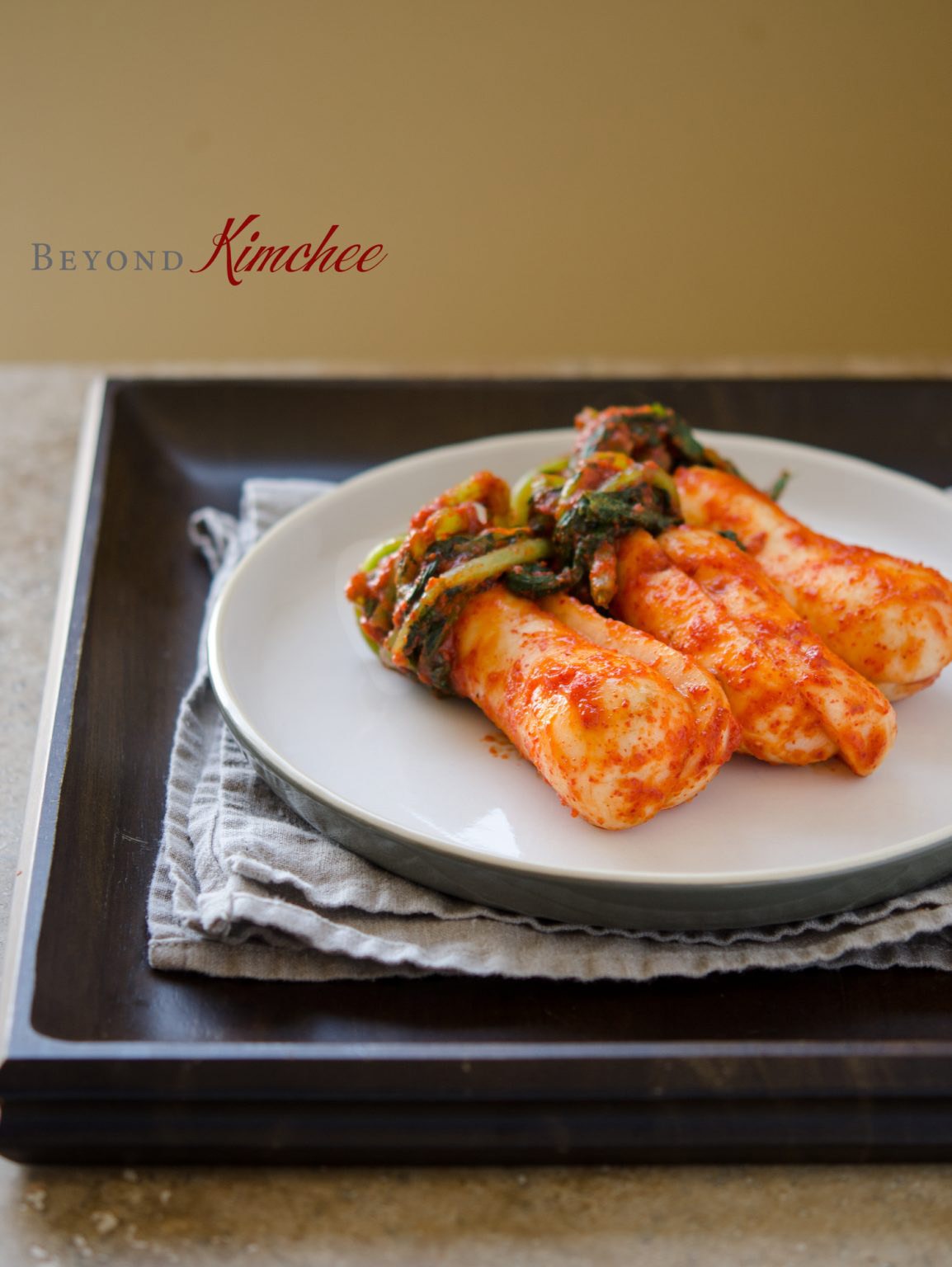 Ponytail kimchi served on a white plate.