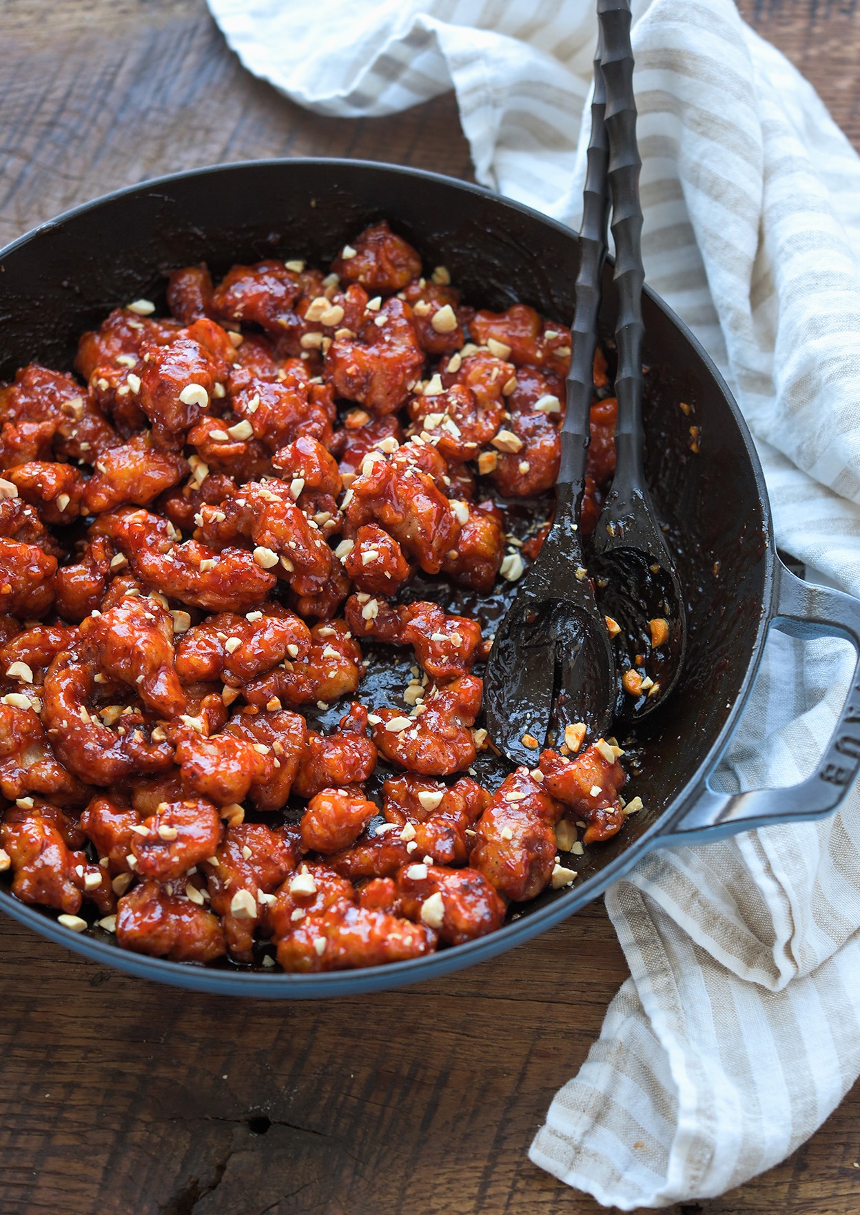 Crispy Korean chicken nuggets coated coated with sauce in a pan.
