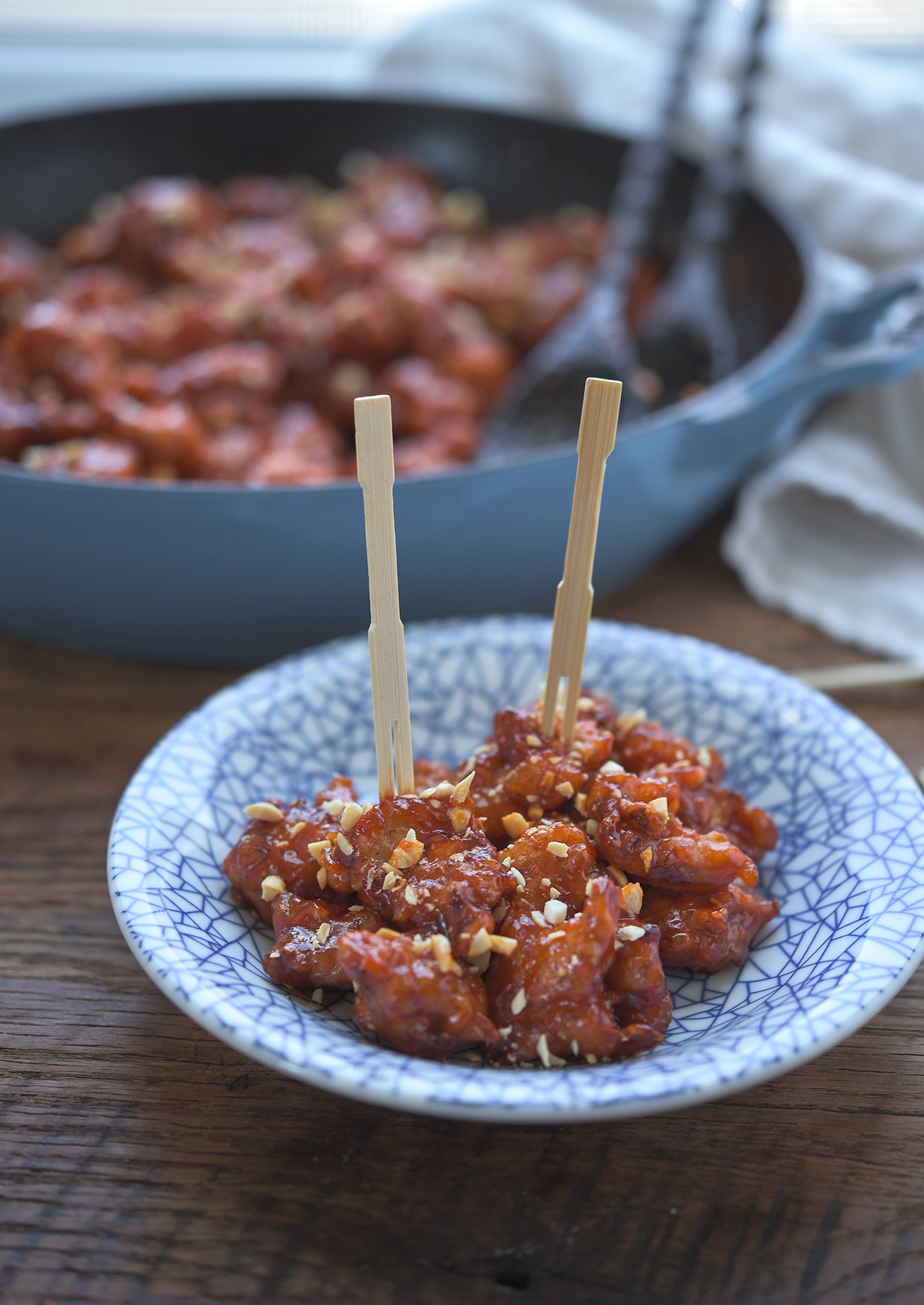 Crispy Korean fried chicken nugget pieces served with wooden picks.