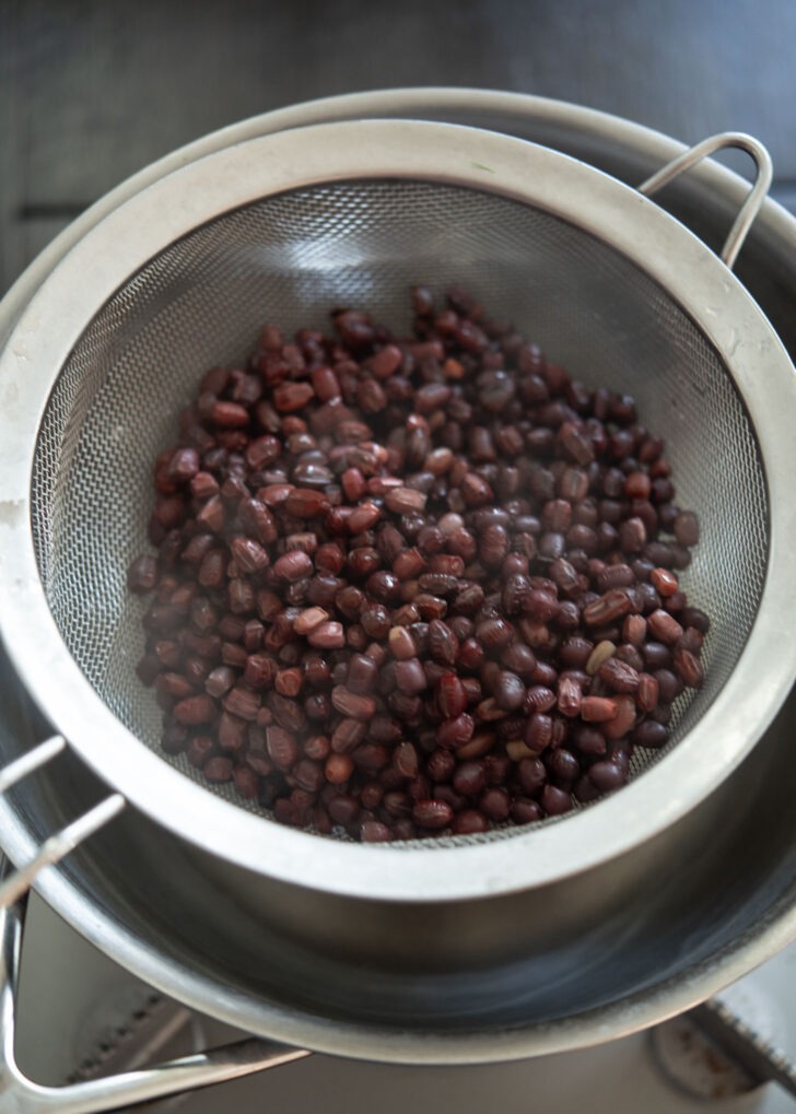 Cooked red beans strained in a colander.