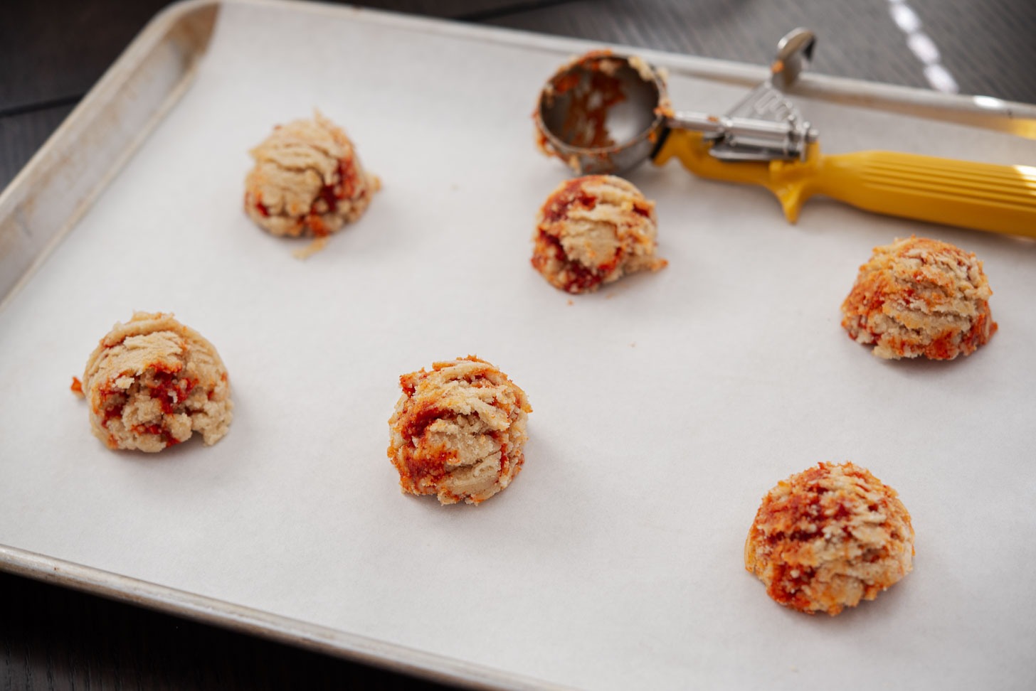 Cookie dough balls are placed on a line cookie sheet.