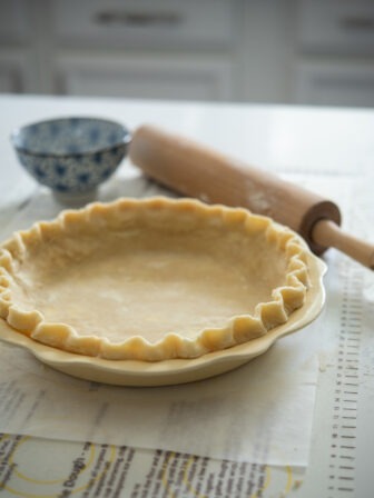 Lard and butter pie crust fluted on a 9-inch pie pan.