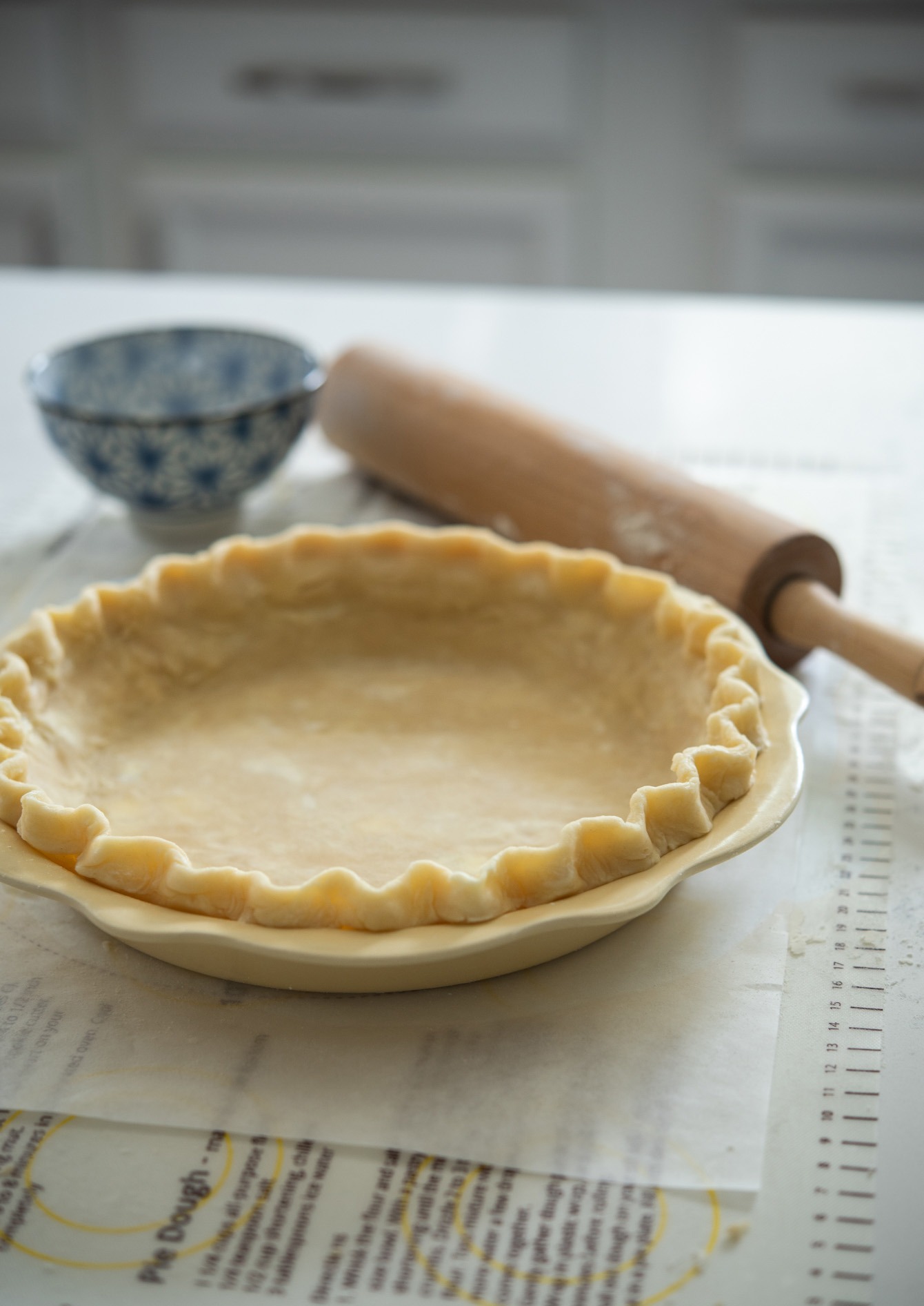 Lard and butter pie crust fluted on a 9-inch pie pan. 