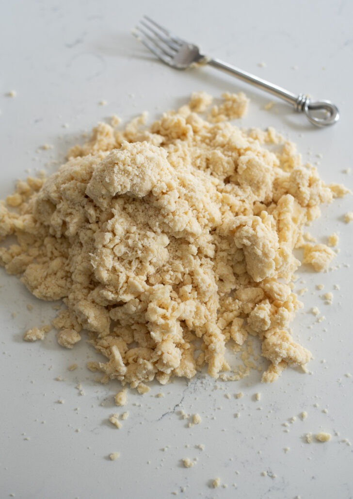 Pie dough crumbs on working surface.