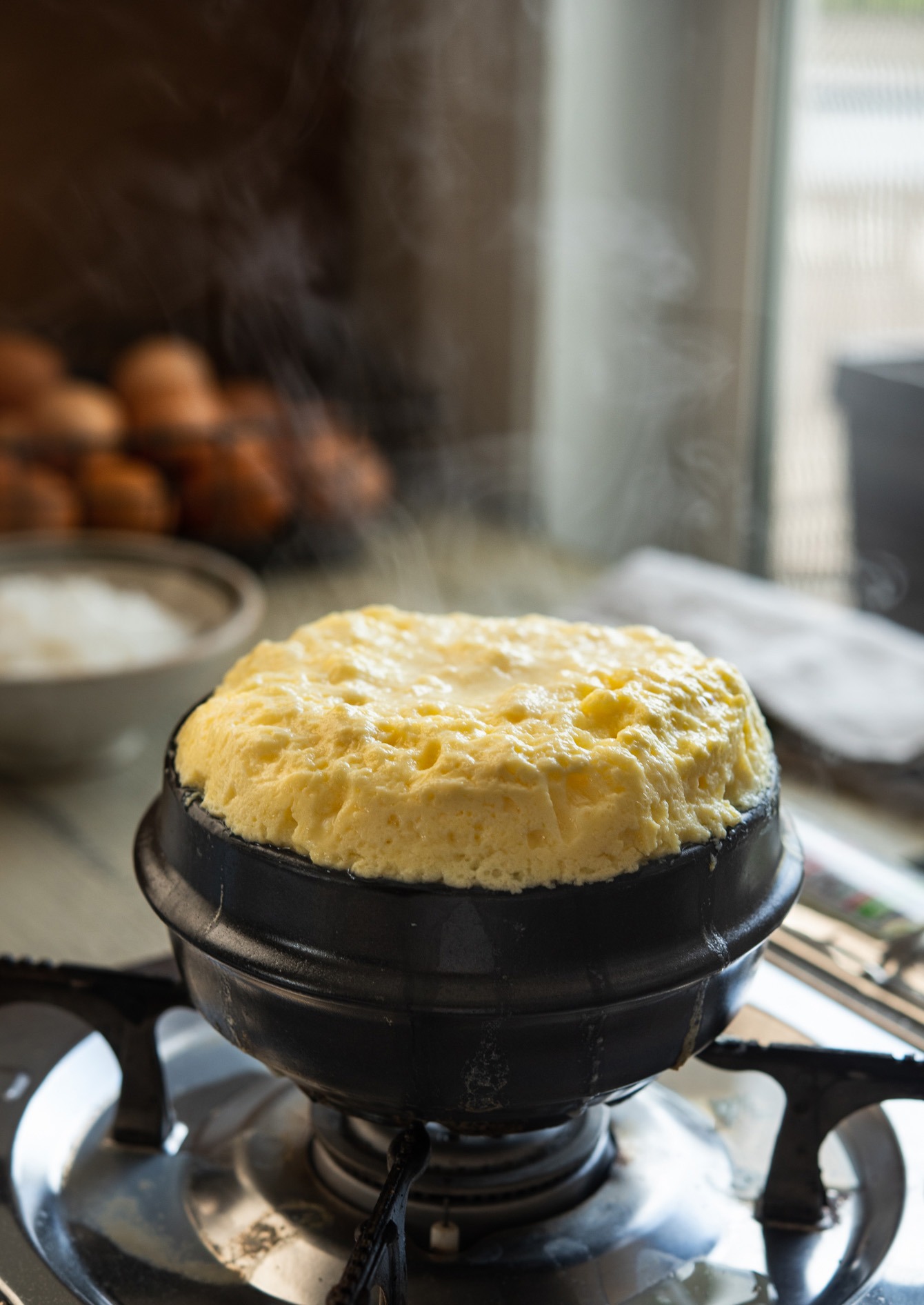 Steaming hot volcanic Korean egg cooked in a stone pot.