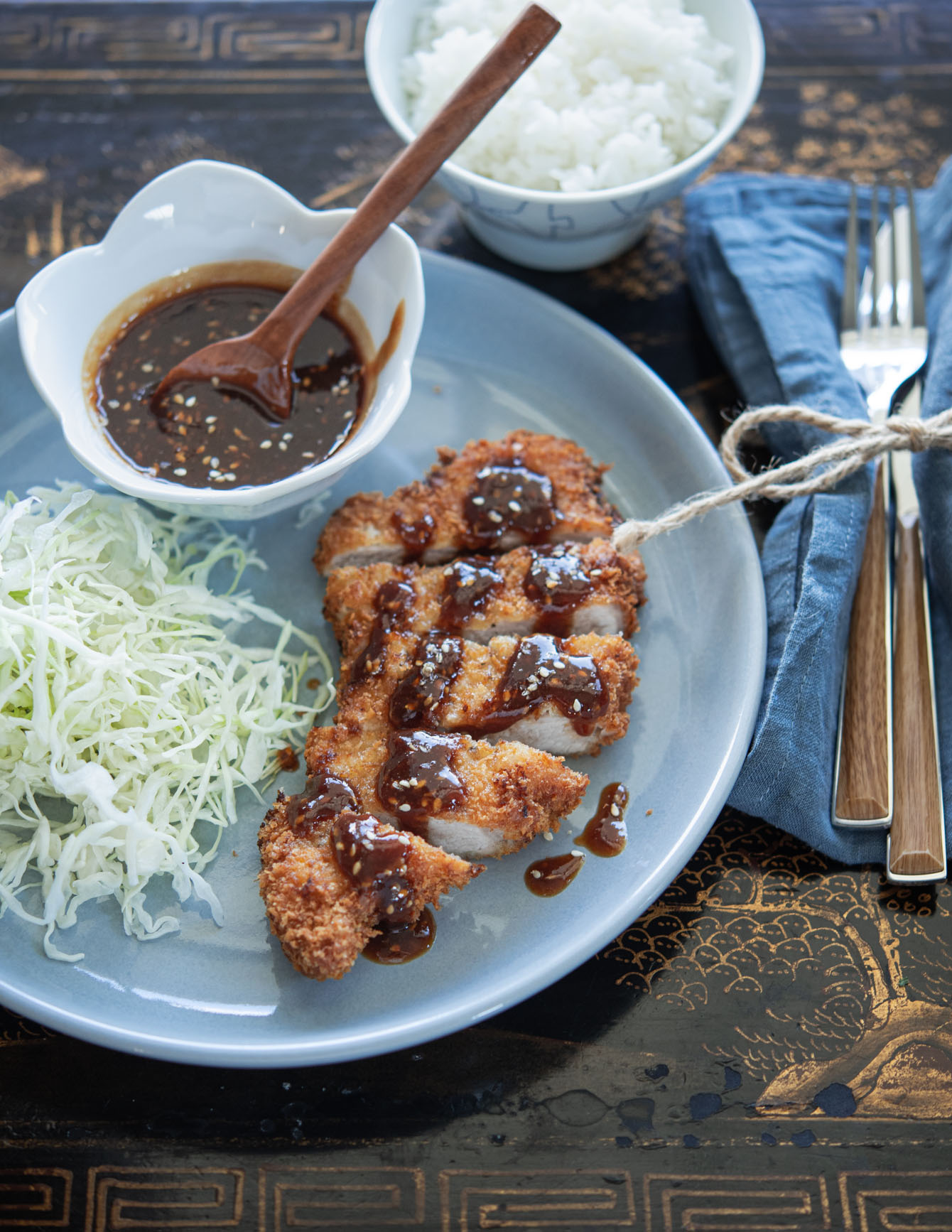Japanese pork cutlet served with homemade tonkatsu sauce and crisp cabbage.