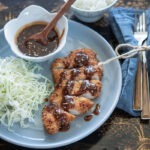 Japanese pork cutlet served with homemade tonkatsu sauce and crisp cabbage.