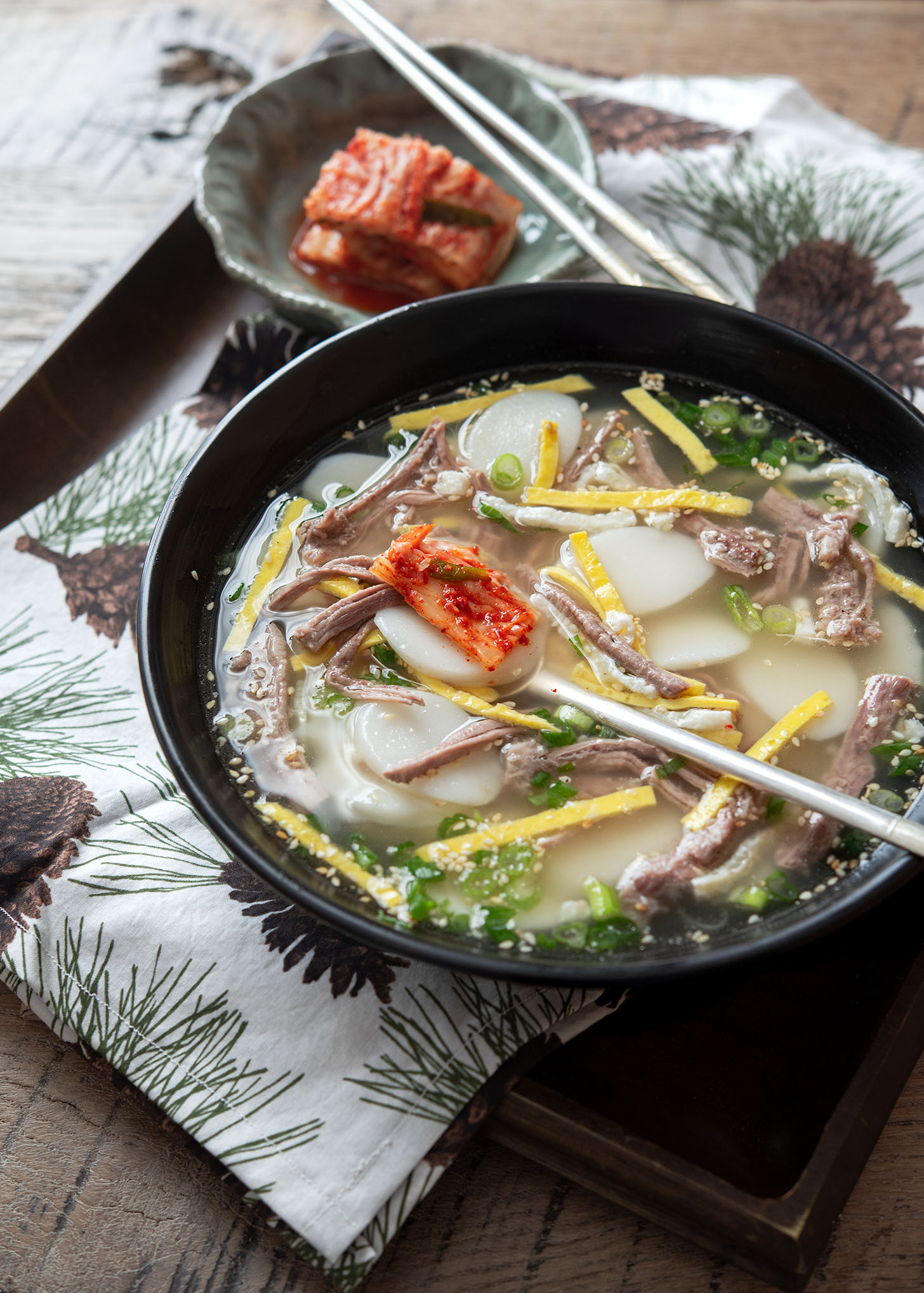 Tteokguk served with kimchi.