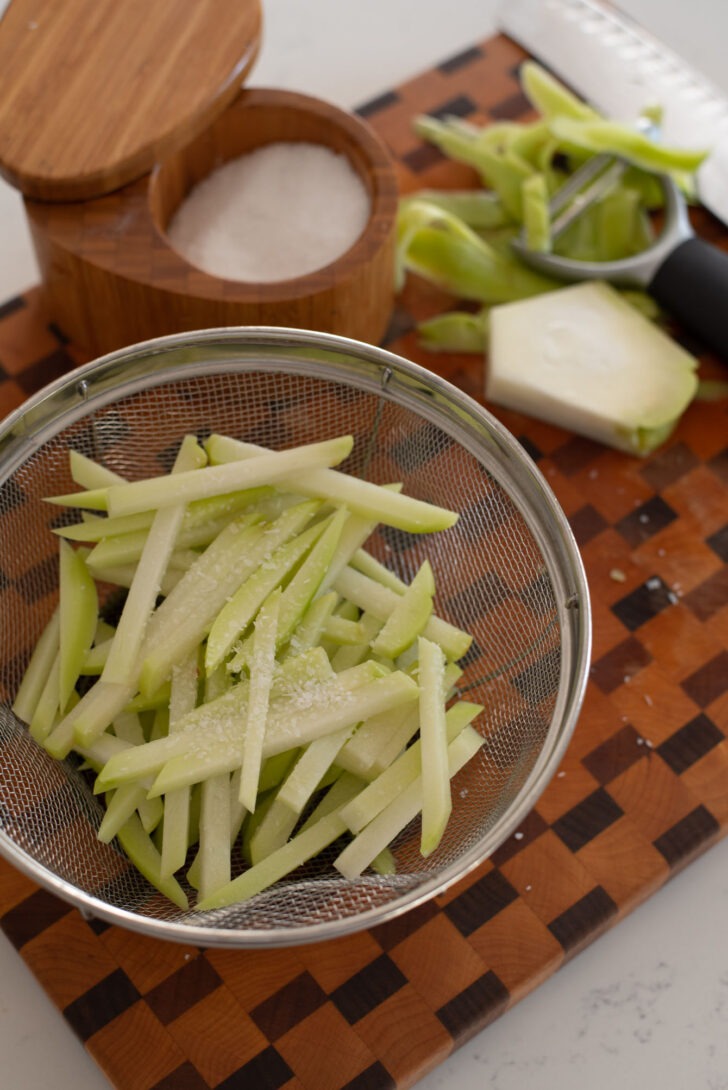 Chayote slices in a colander.