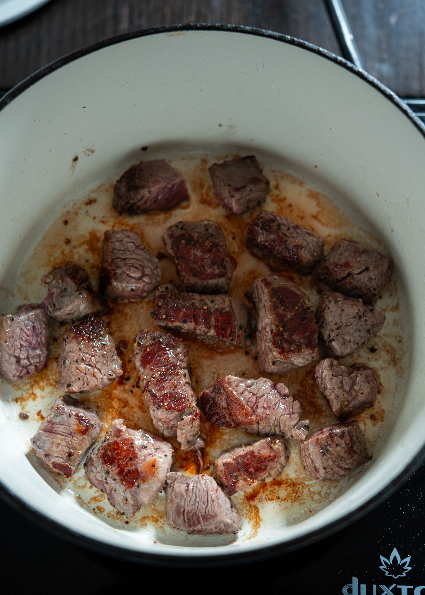 Browning beef pieces to make stew.
