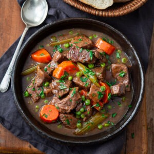Old time beef stew with hearty vegetables in a serving bowl.