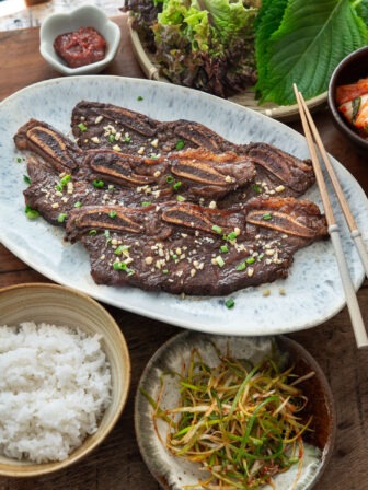 LA galbi served with rice and other side dishes.