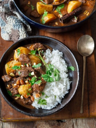 A bowl of beef massaman curry with rice.
