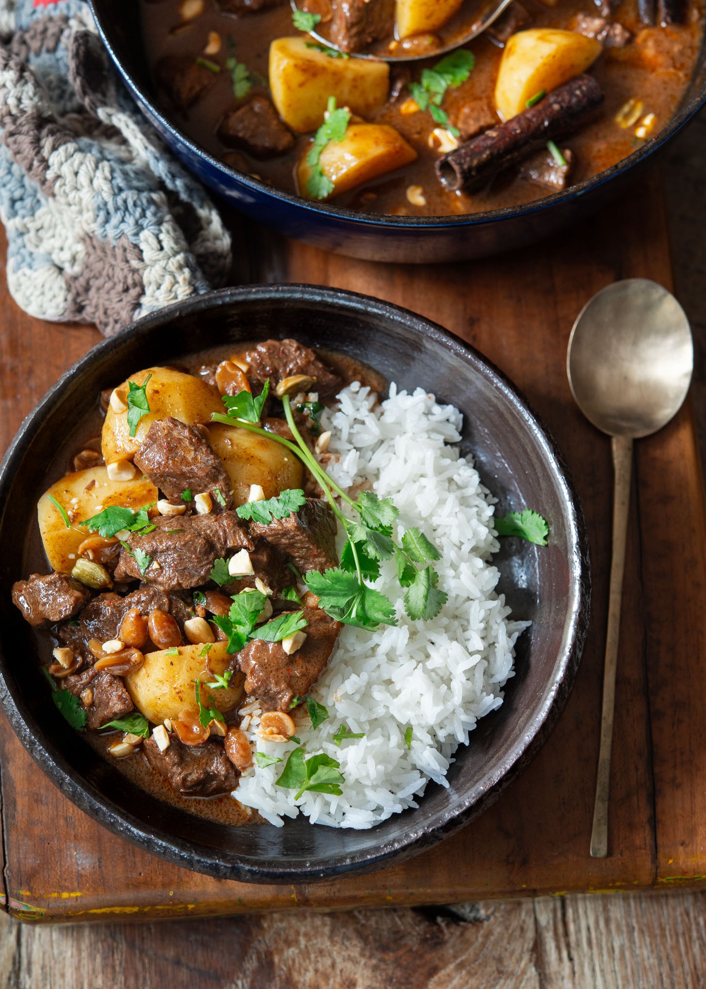 A bowl of beef massaman curry with rice.