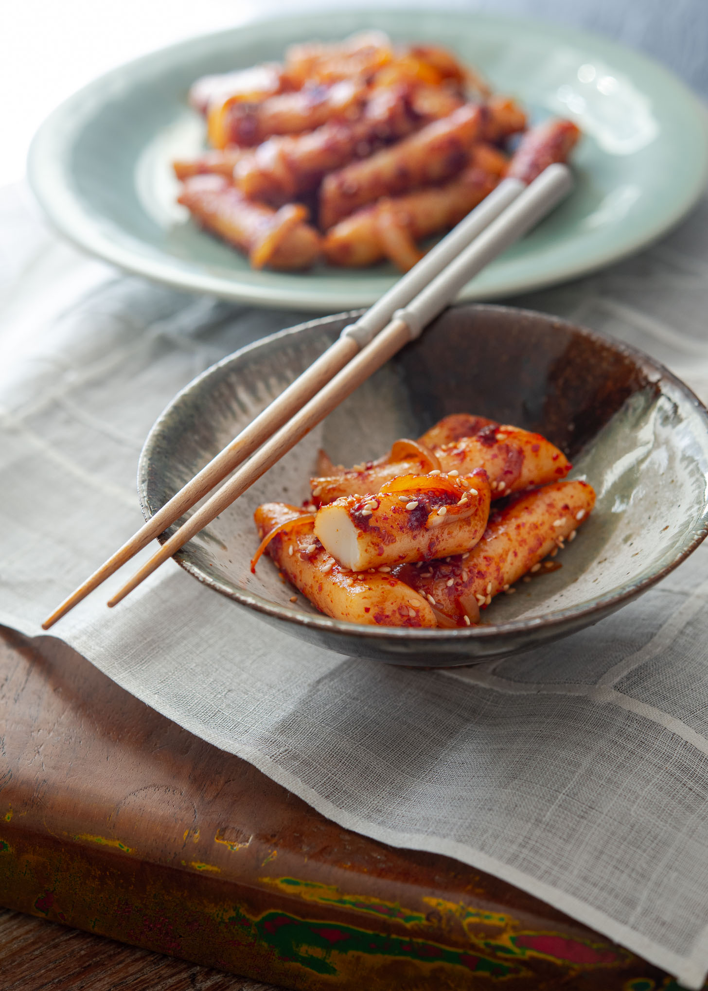 A bowl of Korean style pan fried rice cake.