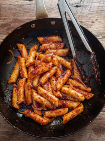 Pan fried rice cake in a skillet.