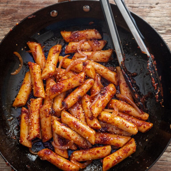 Pan fried rice cake in a skillet.