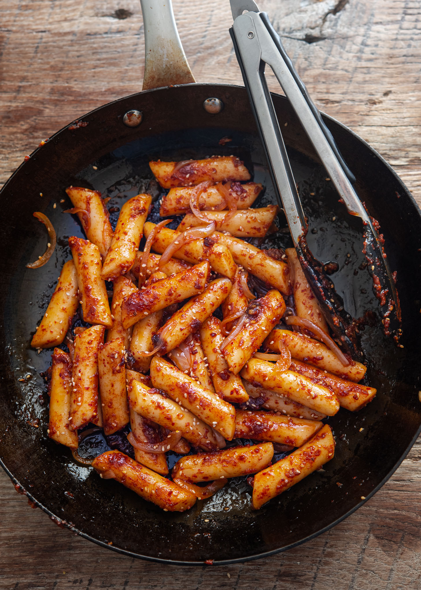 Pan fried rice cake in a skillet.