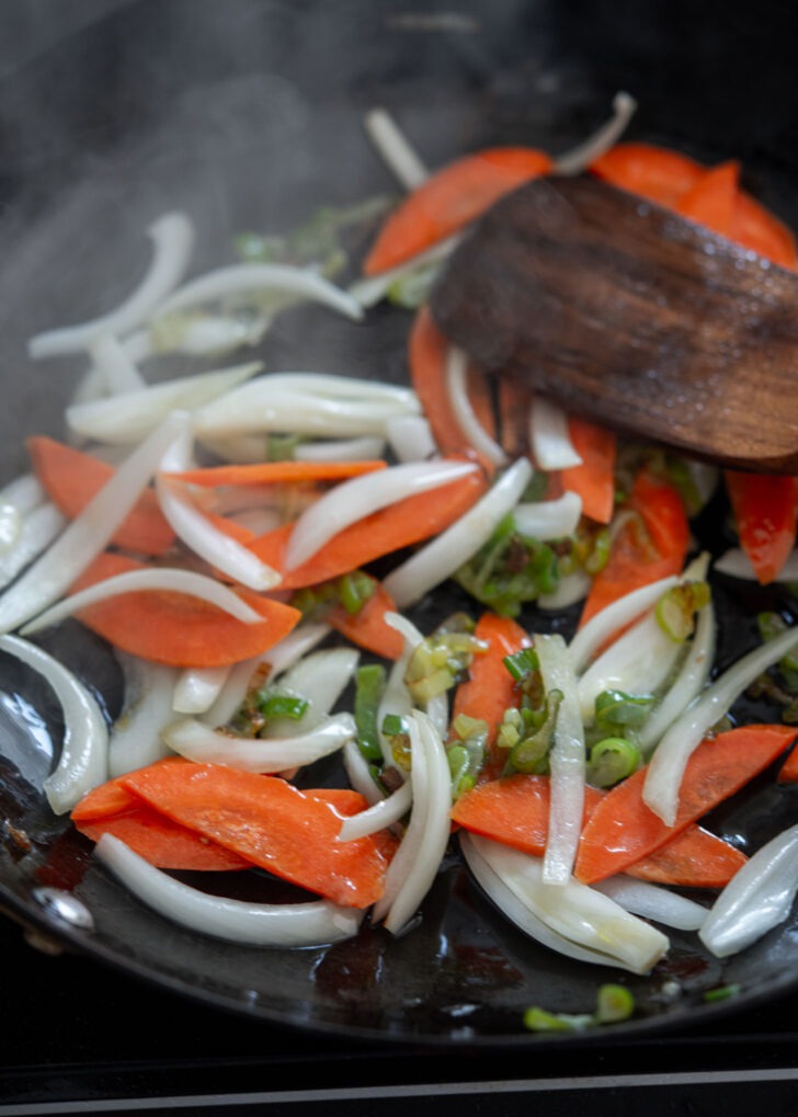 Onion and carrot added to stir-fry.