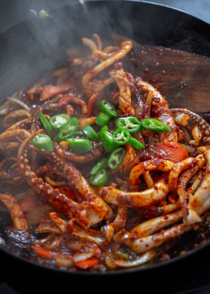 Fresh chili pieces added to squid stir-fry.