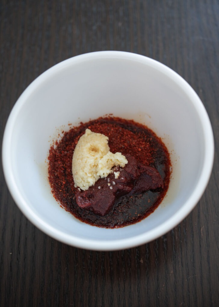 Combining all the sauce ingredients for ojingeo bokkeum in a bowl.