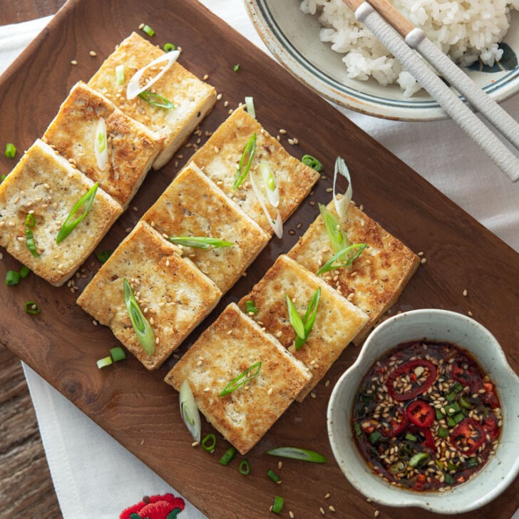 Korean style crispy pan-fried tofu with dipping sauce.