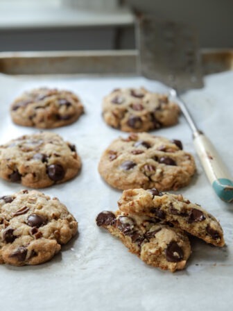 Chewy brown butter chocolate chip cookies on a cookie sheet.