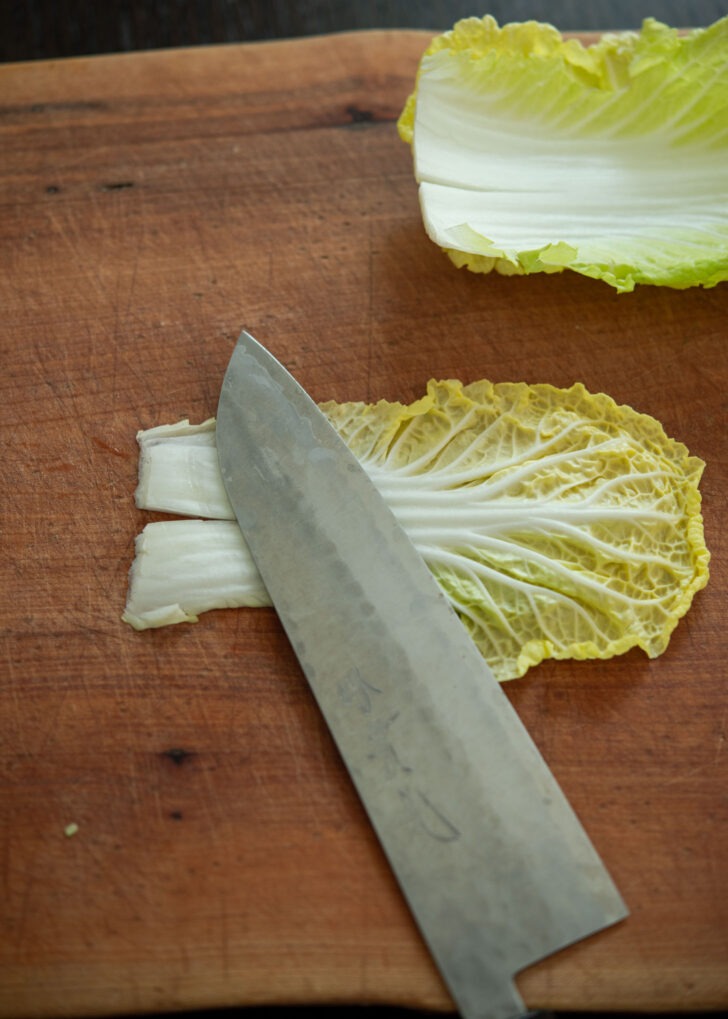 The back of knife pounding cabbage leaf.