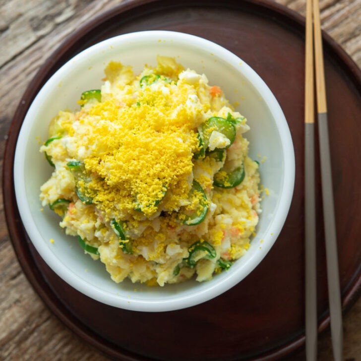 Korean potato salad in a bowl with chopsticks.