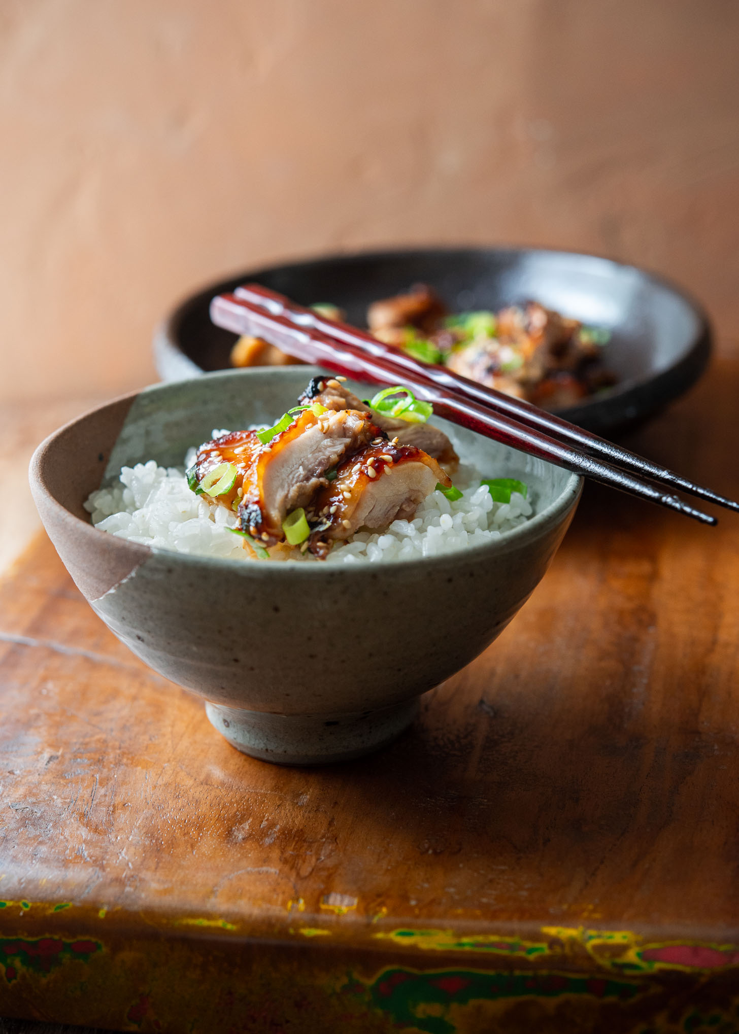  A bowl of rice topped with miso chicken thighs.