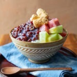 Patbingsu adorned with fresh fruits in a serving bowl.