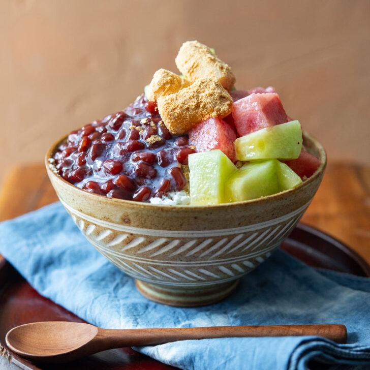 Patbingsu adorned with fresh fruits in a serving bowl.