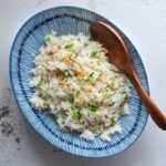 Garlic fried rice served in a bowl with a spoon.