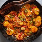 Spicy potatoes braised in a skillet.