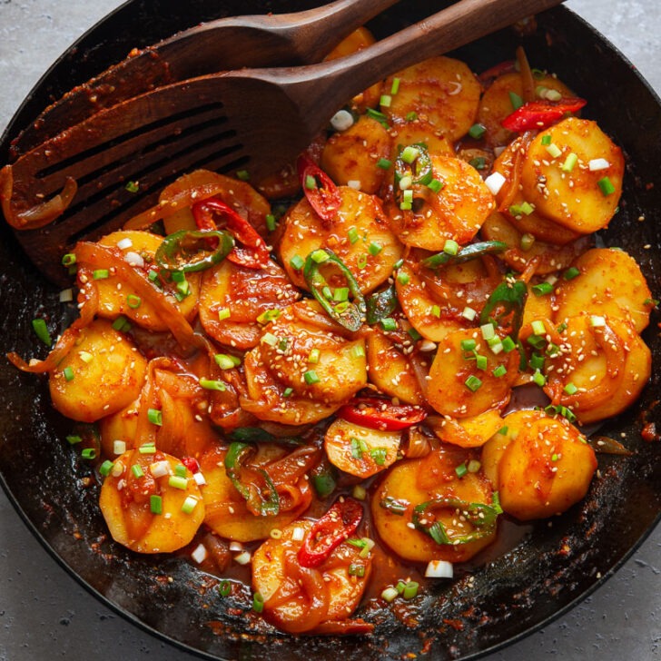 Spicy potatoes braised in a skillet.