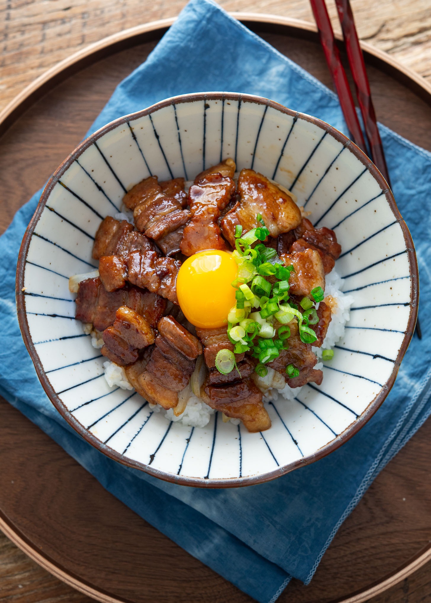 Butadon with pork belly and egg yolk in a serving bowl.