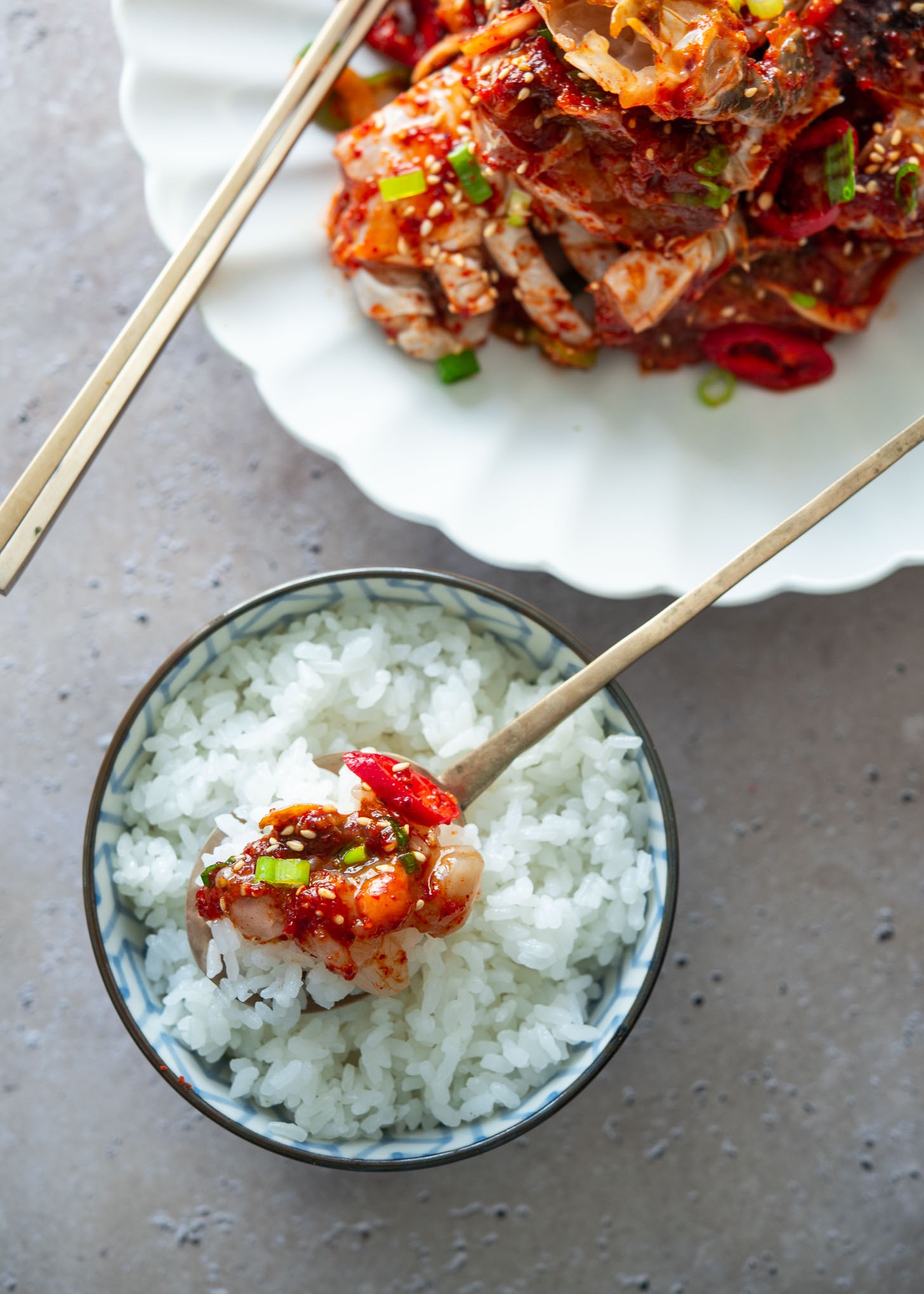 Raw crab meat on a spoonful of rice.