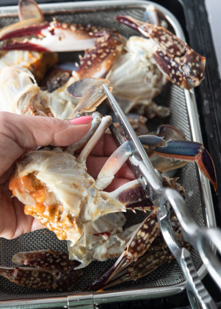 A pair of scissor cutting of crab legs.