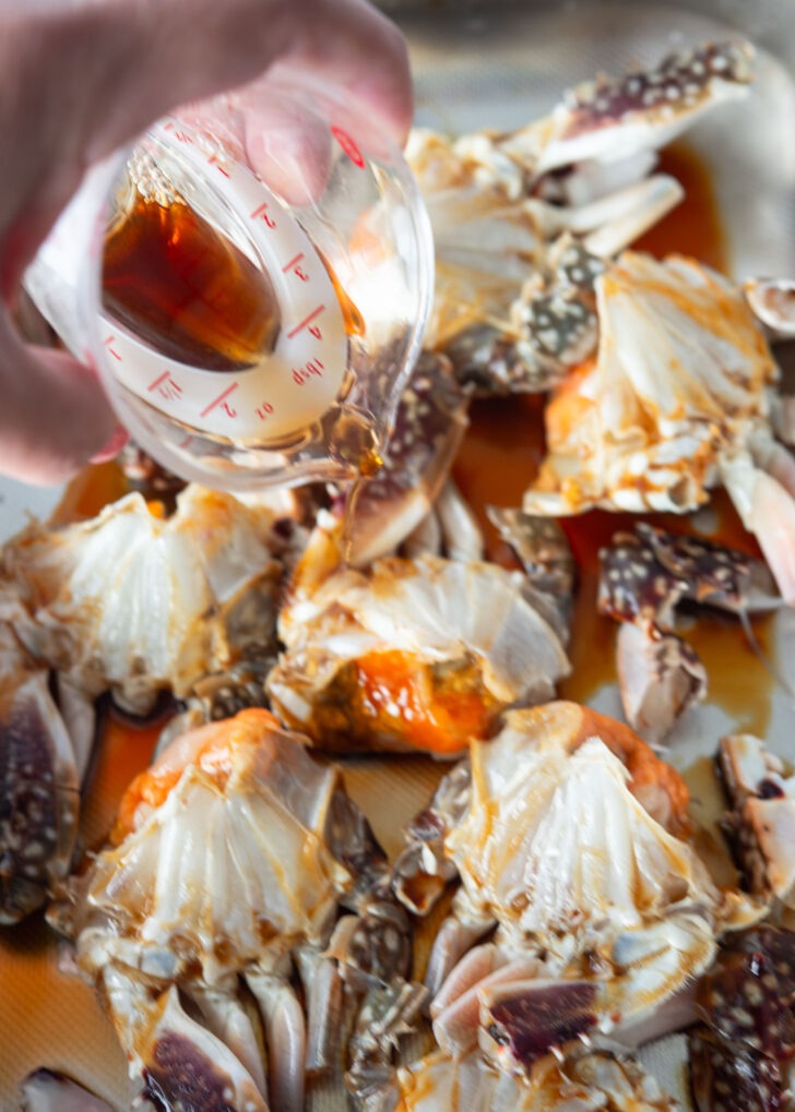 Drizzling soy sauce mixture over crab.