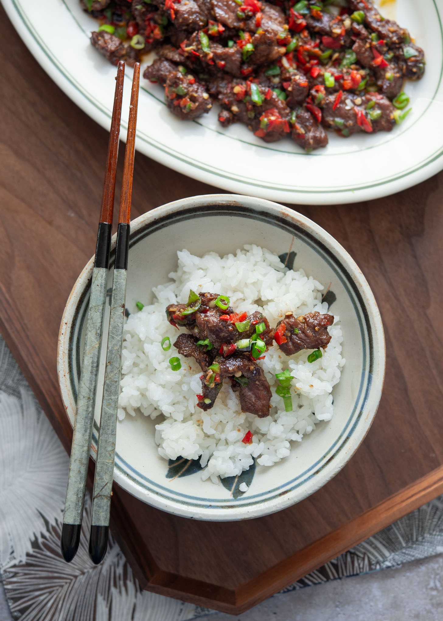 Stir-fried cumin beef slices on a bowl of rice.