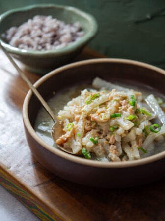A bowl of Korean radish and clams served with rice.